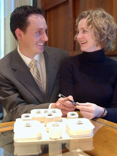 Lisa Curry picked the same engagement ring that her fiancé John Flora had chosen earlier. At top, Curry takes a moment to examine the diamond.